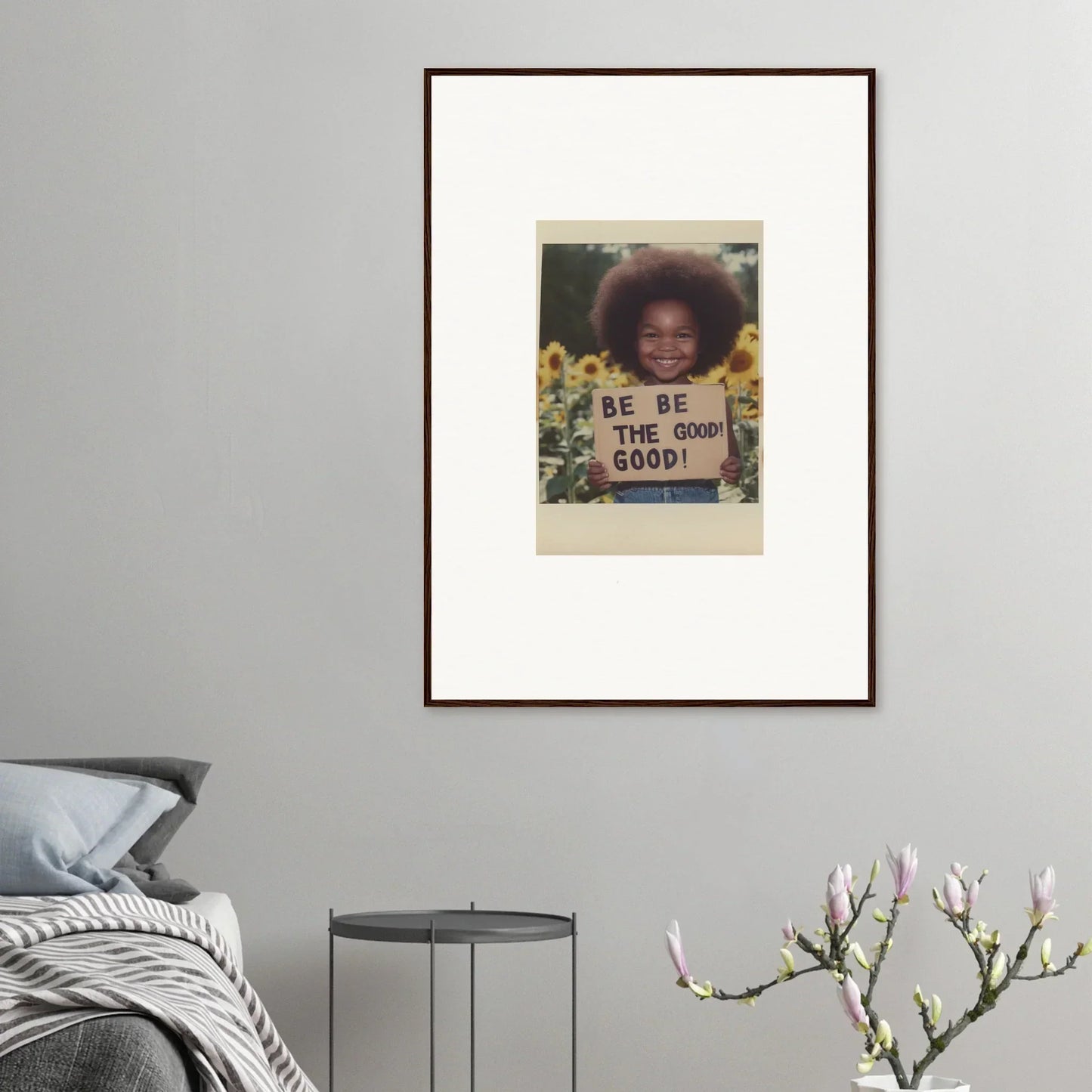 Framed wall art of a person with a BE THE GOOD sign in sunflowers for Sunflower’s Gentle Whisper