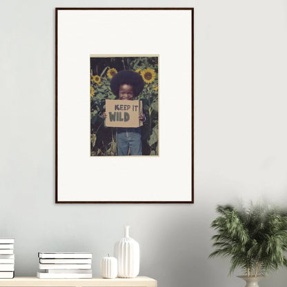 Framed canvas print of a person with a KEEP IT WILD sign in sunflowers and greenery