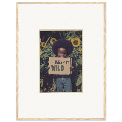 Framed photo of a child with a KEEP IT WILD sign among sunflowers for room decoration