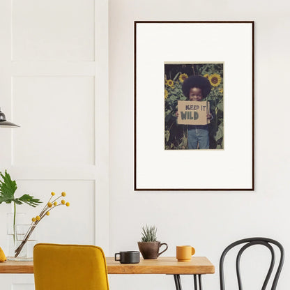 Framed canvas print of a person with a Keep it Wild sign among sunflowers for room decoration