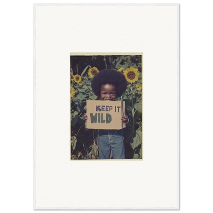 Person with KEEP IT WILD sign in sunflowers for a vibrant Cosmos Unchained canvas print