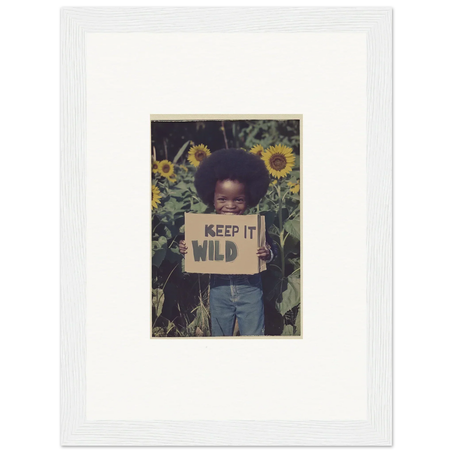 Person with a KEEP IT WILD sign in sunflowers, perfect for Cosmos Unchained room decoration