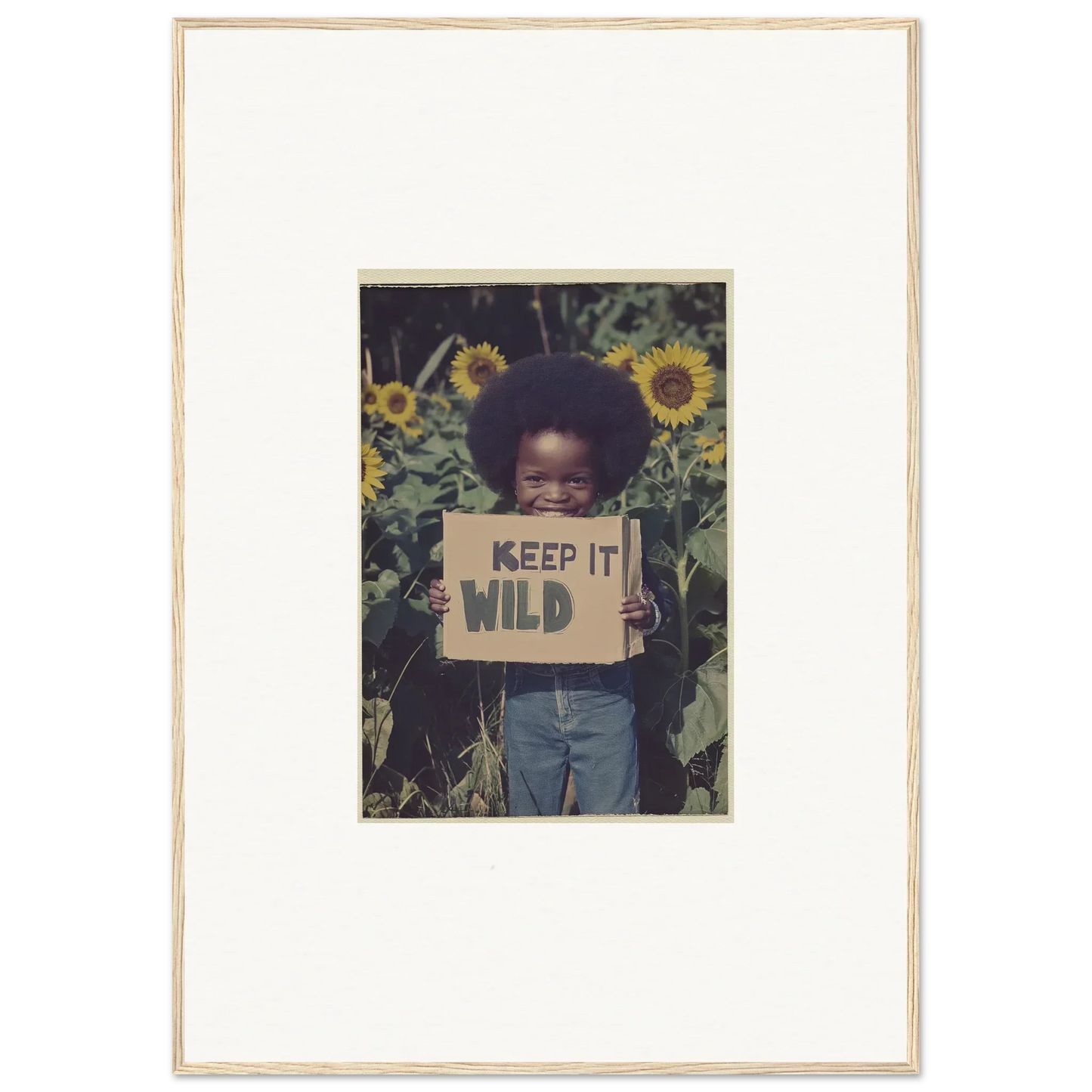 Framed canvas print of a person with a KEEP IT WILD sign in a sunflower field for room decoration