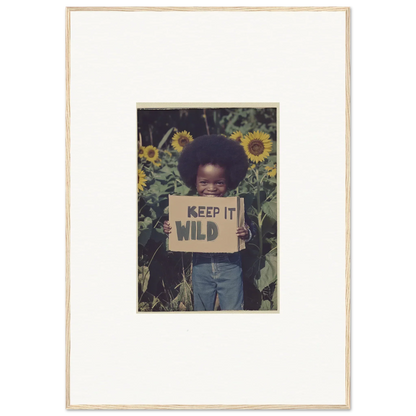 Framed canvas print of a person with a KEEP IT WILD sign in a sunflower field for room decoration