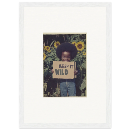 Framed photo of a child with a KEEP IT WILD sign in sunflowers for room decoration