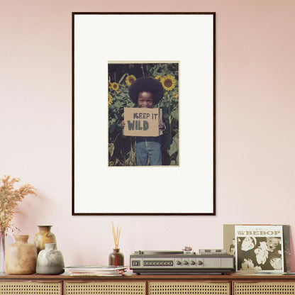 Framed photo of someone with a KEEP IT WILD sign in sunflowers for room decoration