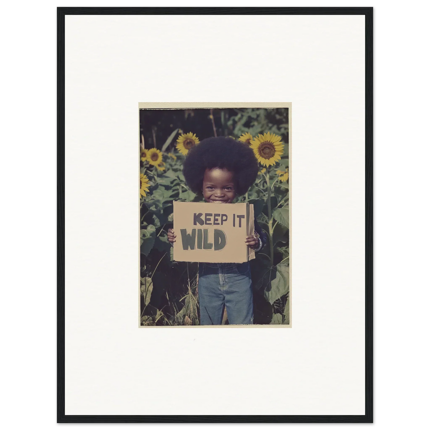 Framed photo of a child with KEEP IT WILD sign in sunflowers for fun room decoration