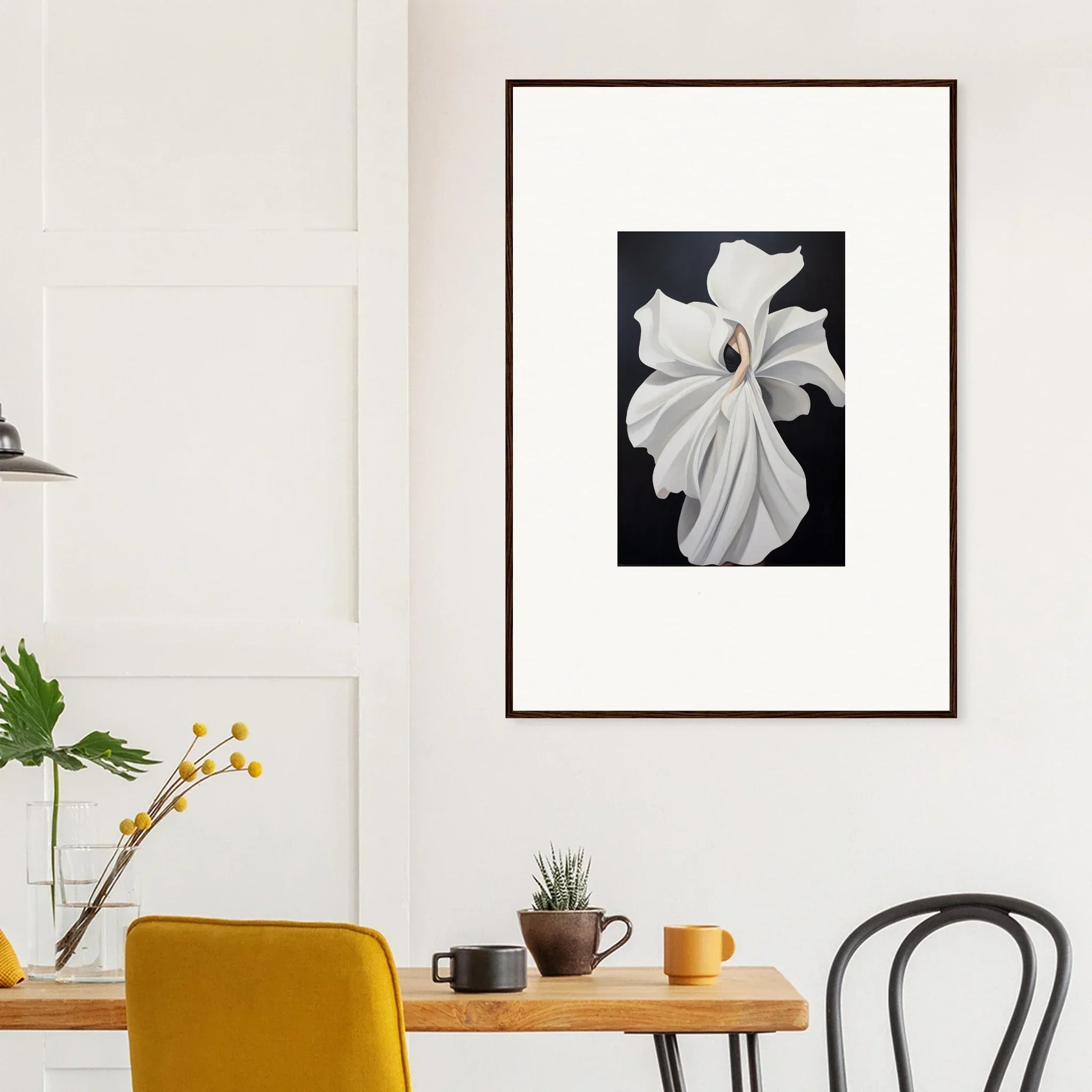 Framed black and white wall art of a white flower highlighting petal fluidity in room decor