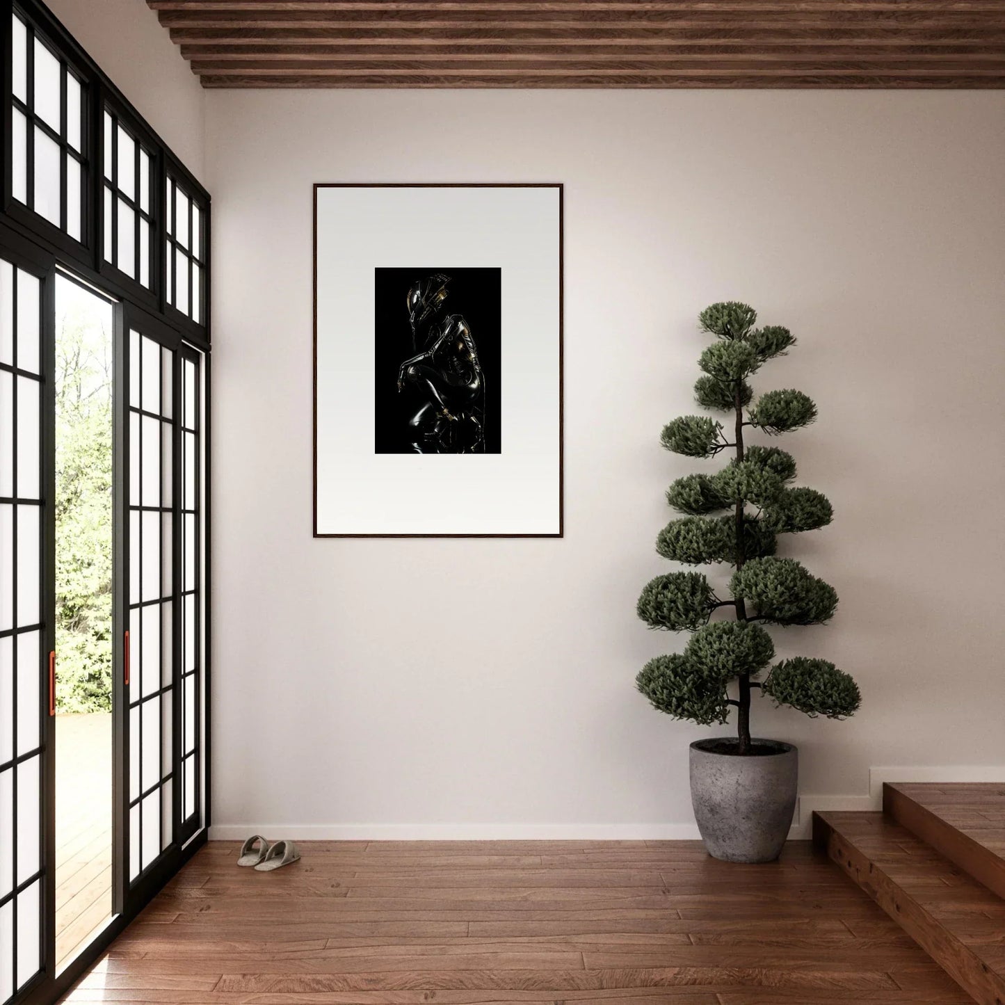 Minimalist interior space featuring a framed black and white artwork, potted topiary tree, and sliding glass doors.