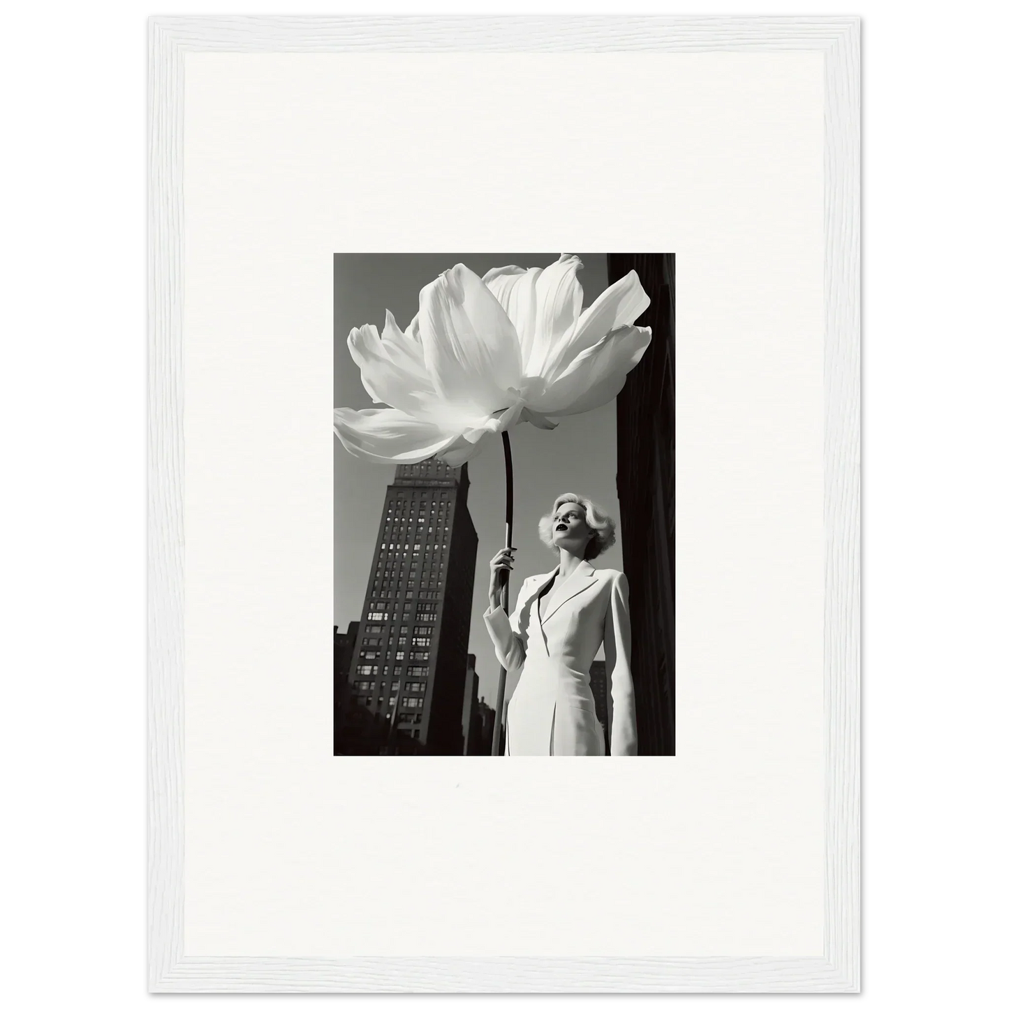 A black and white photograph of a person standing beneath an oversized flower.