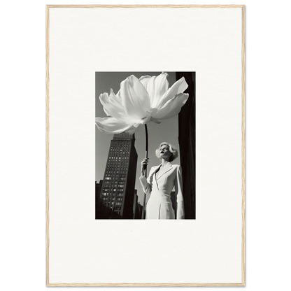 Black and white photograph of a woman standing next to an oversized flower sculpture against a cityscape backdrop.