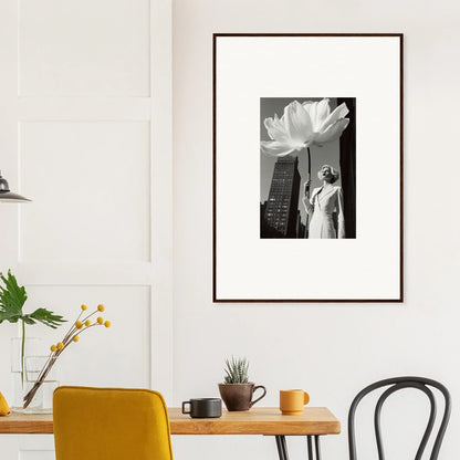 Framed black and white photograph of a flower and statue against a cityscape.