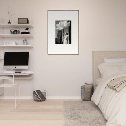 Minimalist bedroom with white walls, floating shelves, and a framed black-and-white photograph.