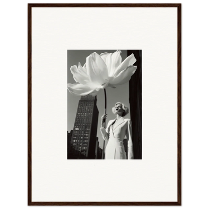 A woman in a white dress holding an oversized flower against a cityscape backdrop.