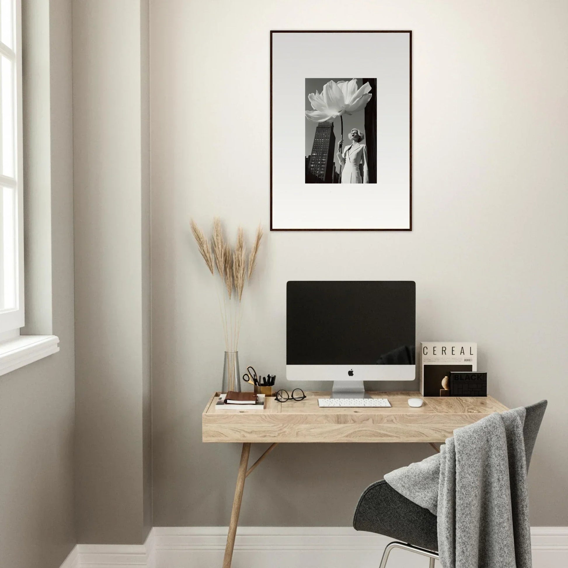 Minimalist wooden desk with a computer monitor and office accessories.