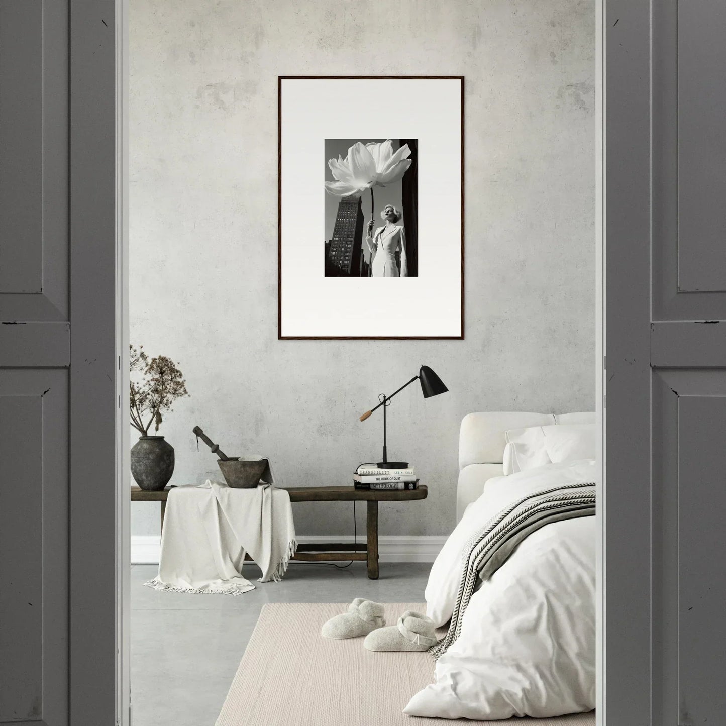 Minimalist bedroom with a framed black and white photograph as the focal point.