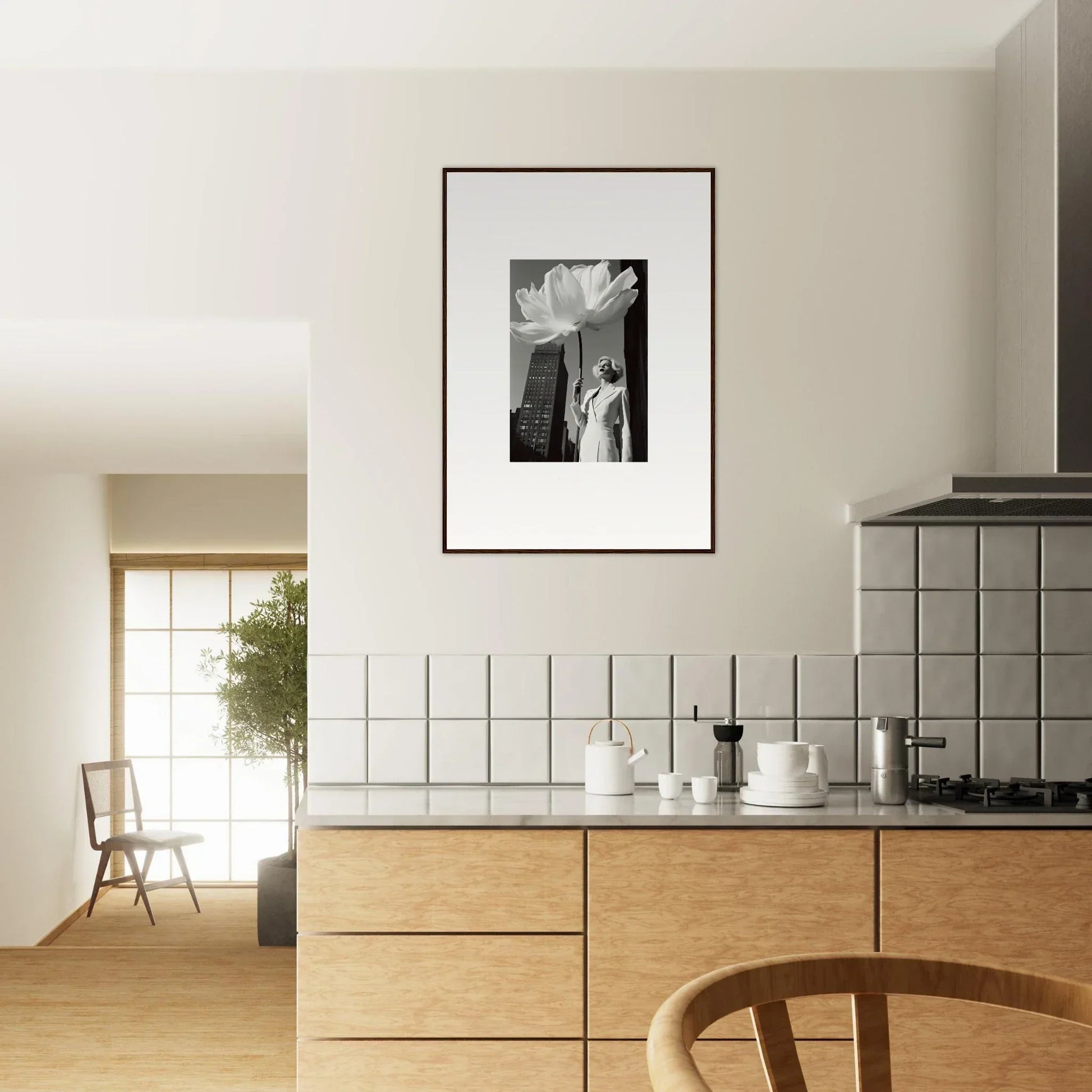 Modern kitchen with wooden cabinets, tiled backsplash, and framed black-and-white artwork.