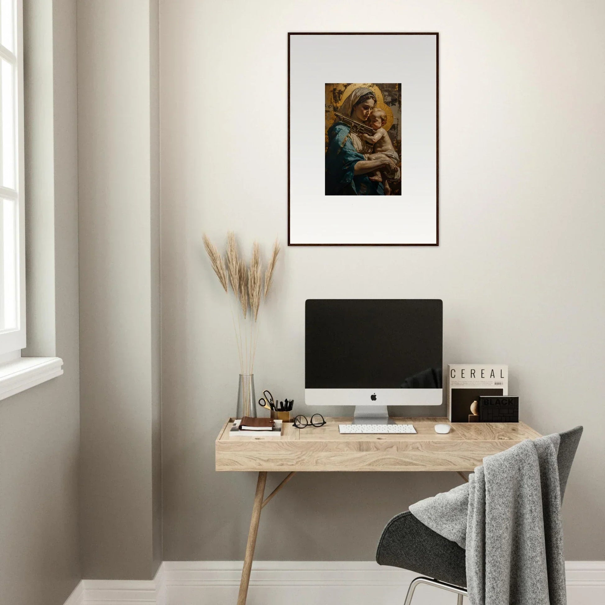 Minimalist wooden desk with a computer and Loving Sentinence canvas print above