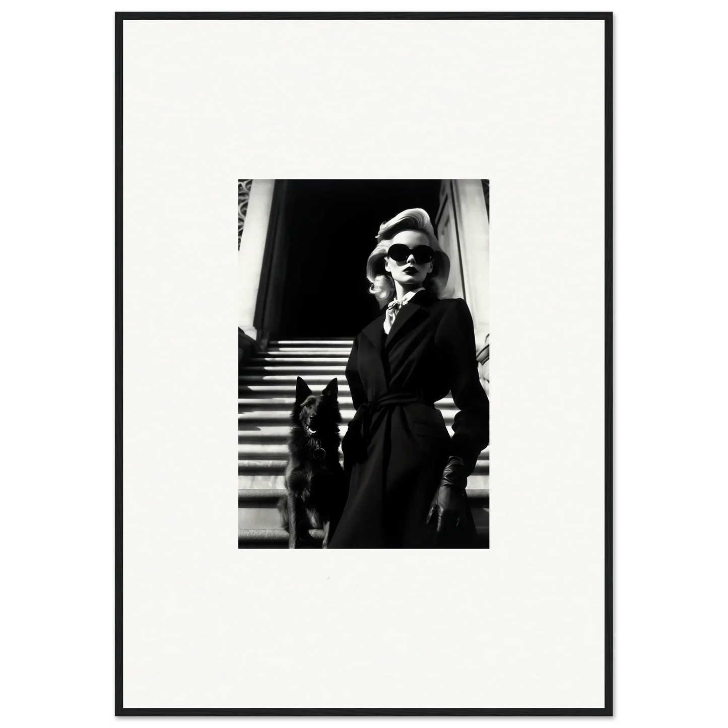 Black and white wall art of a woman in a dark coat with a dog on stairs