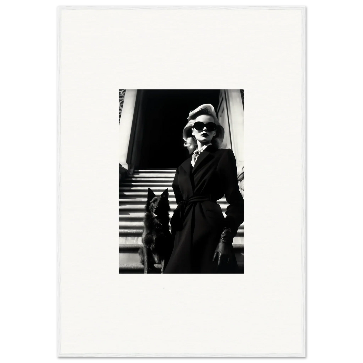 Black and white wall art of a woman in a dark coat with a dog on stairs