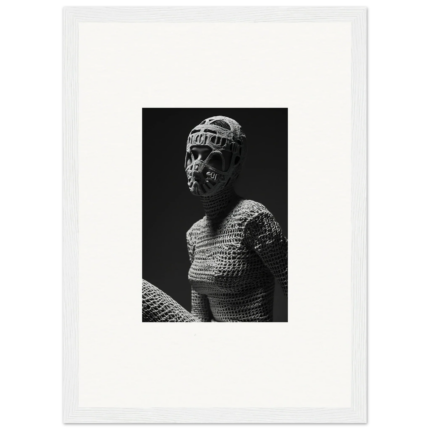 Black and white photograph of a figure wearing textured clothing and a head covering.