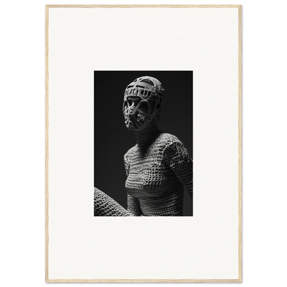 Black and white photograph of a figure wearing a mask and textured, woven clothing.