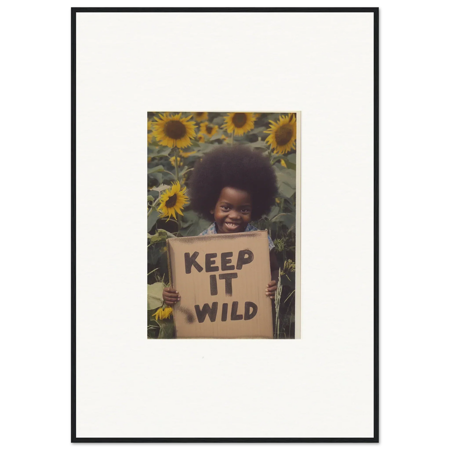 Framed photo of a KEEP IT WILD sign among sunflowers in Visions Bloom Exuberance