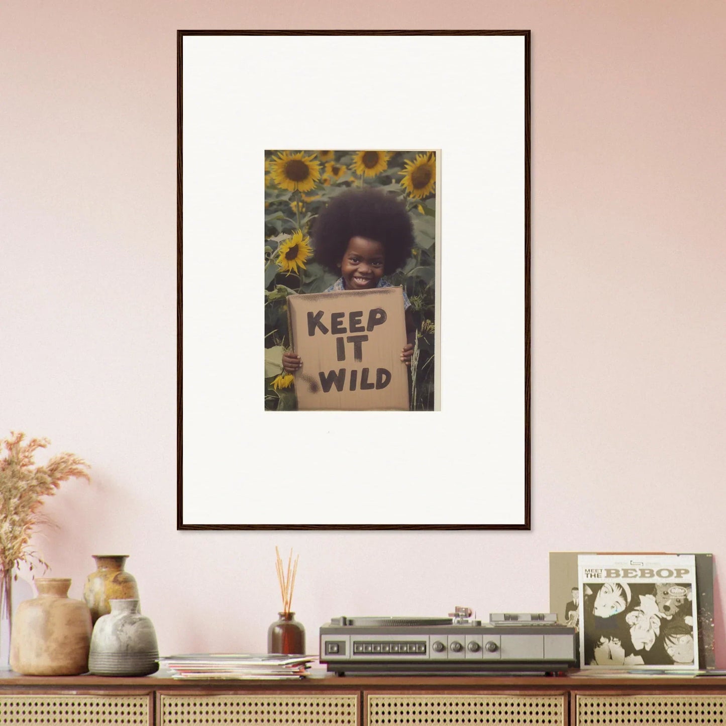 Framed photo of a person with a Keep It Wild sign in sunflowers, Visions Bloom Exuberance