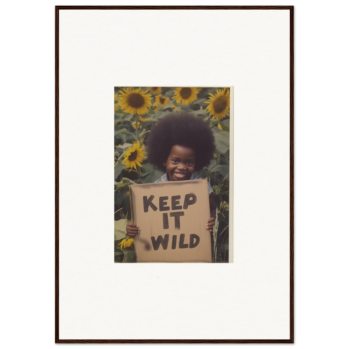 Framed photo of a person with a KEEP IT WILD sign among sunflowers from Visions Bloom Exuberance