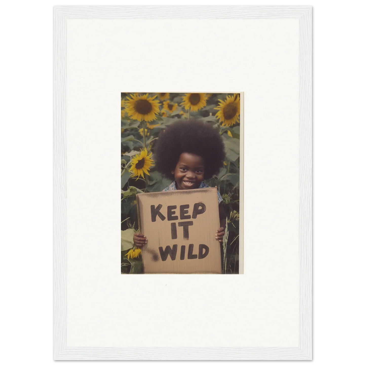 Framed photo of a person holding a KEEP IT WILD sign in sunflowers, Visions Bloom Exuberance