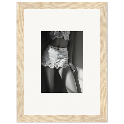 Black and white photograph of a woman’s lower torso wearing lace-trimmed shorts.