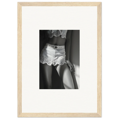 Black and white photograph of a woman’s lower torso wearing lace-trimmed shorts.