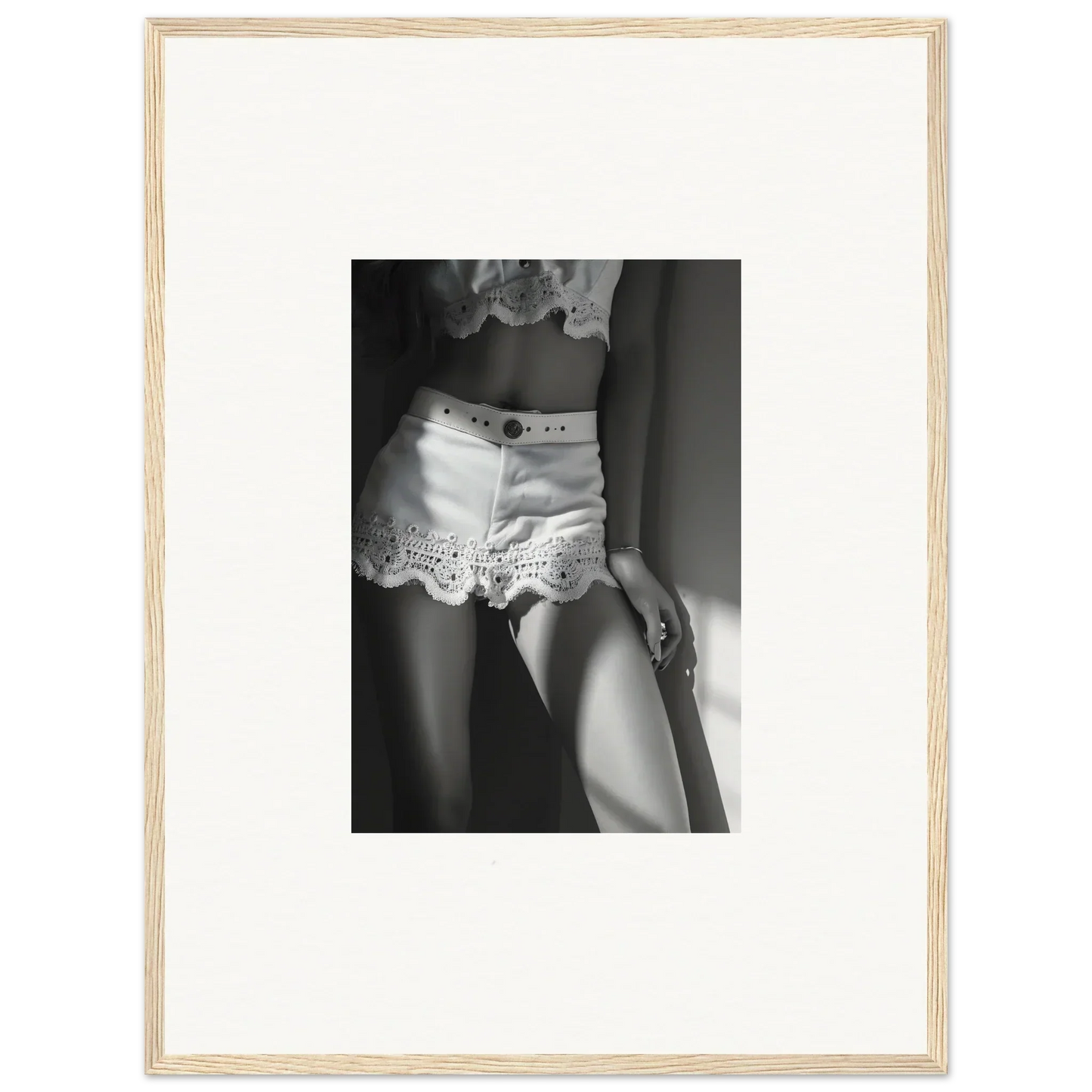 Black and white photograph of a person wearing lacy white shorts.