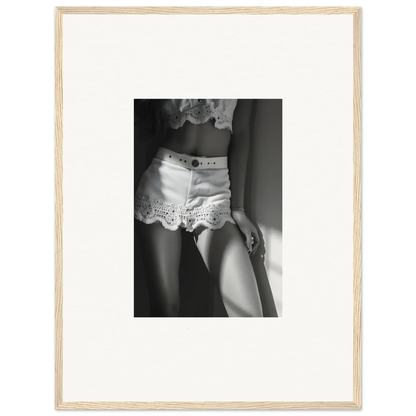 Black and white photograph of a person wearing lacy white shorts.