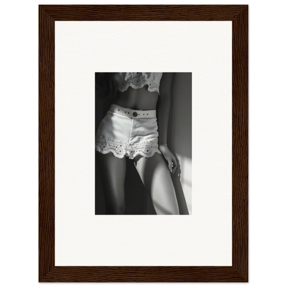 Framed black and white photograph showing a woman’s lower torso wearing lacy white shorts.