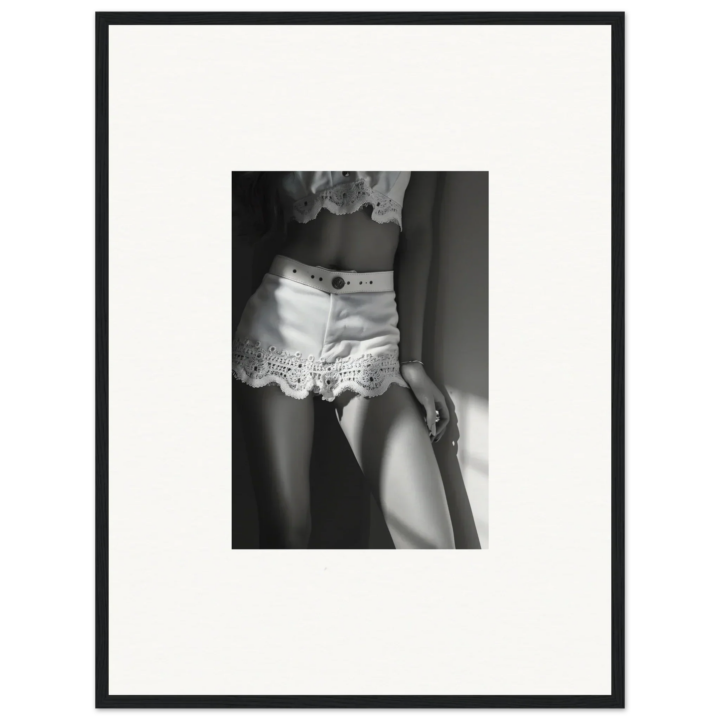 Black and white photograph of a woman wearing lace-trimmed shorts.