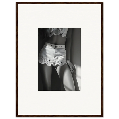 Black and white photograph of a person wearing lace-trimmed shorts.