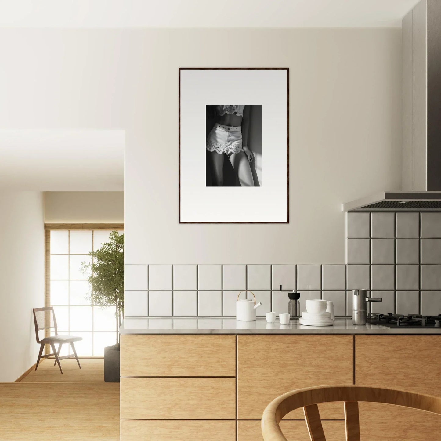 Modern kitchen with wooden cabinetry and a framed black-and-white photograph on the wall.