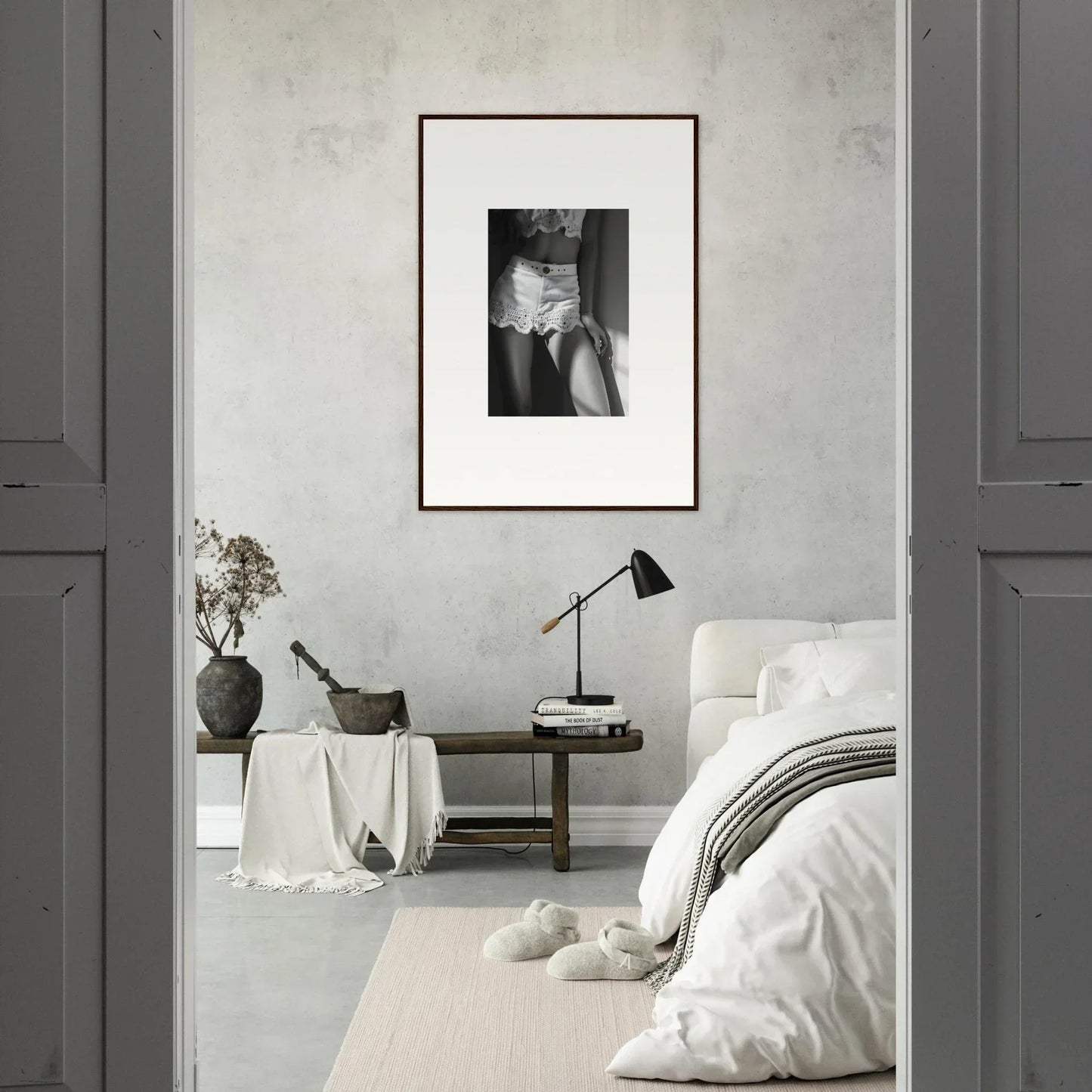 Framed black and white photograph of a person’s torso and hands hanging on a wall.