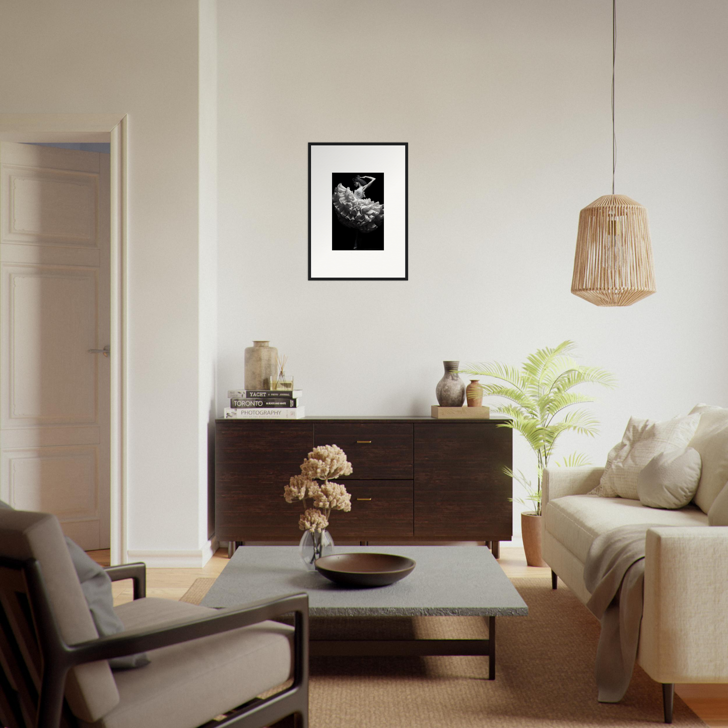 Living room with modern, minimalist decor featuring a dark wood sideboard and neutral-toned furniture.