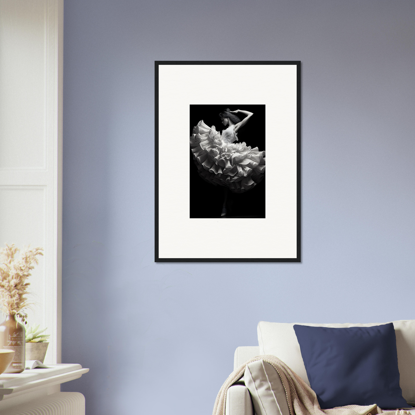 Framed black and white photograph of a figure emerging from or submerged in billowing fabric or clouds.