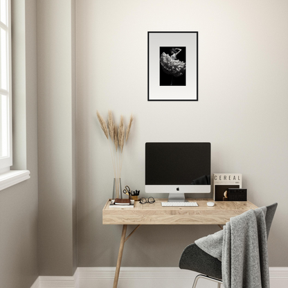 Minimalist wooden desk with a computer monitor and decorative accessories.