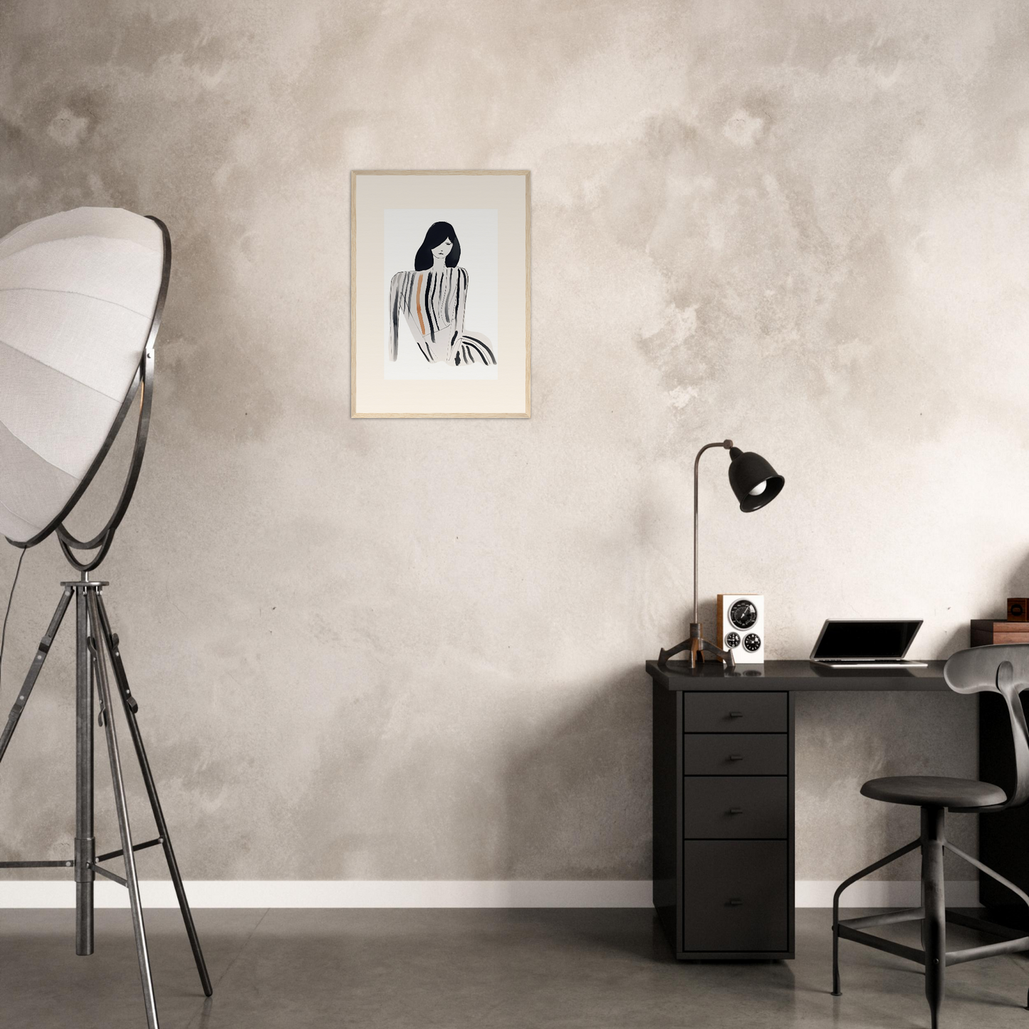 Minimalist home office workspace with a desk, chair, and wall art.