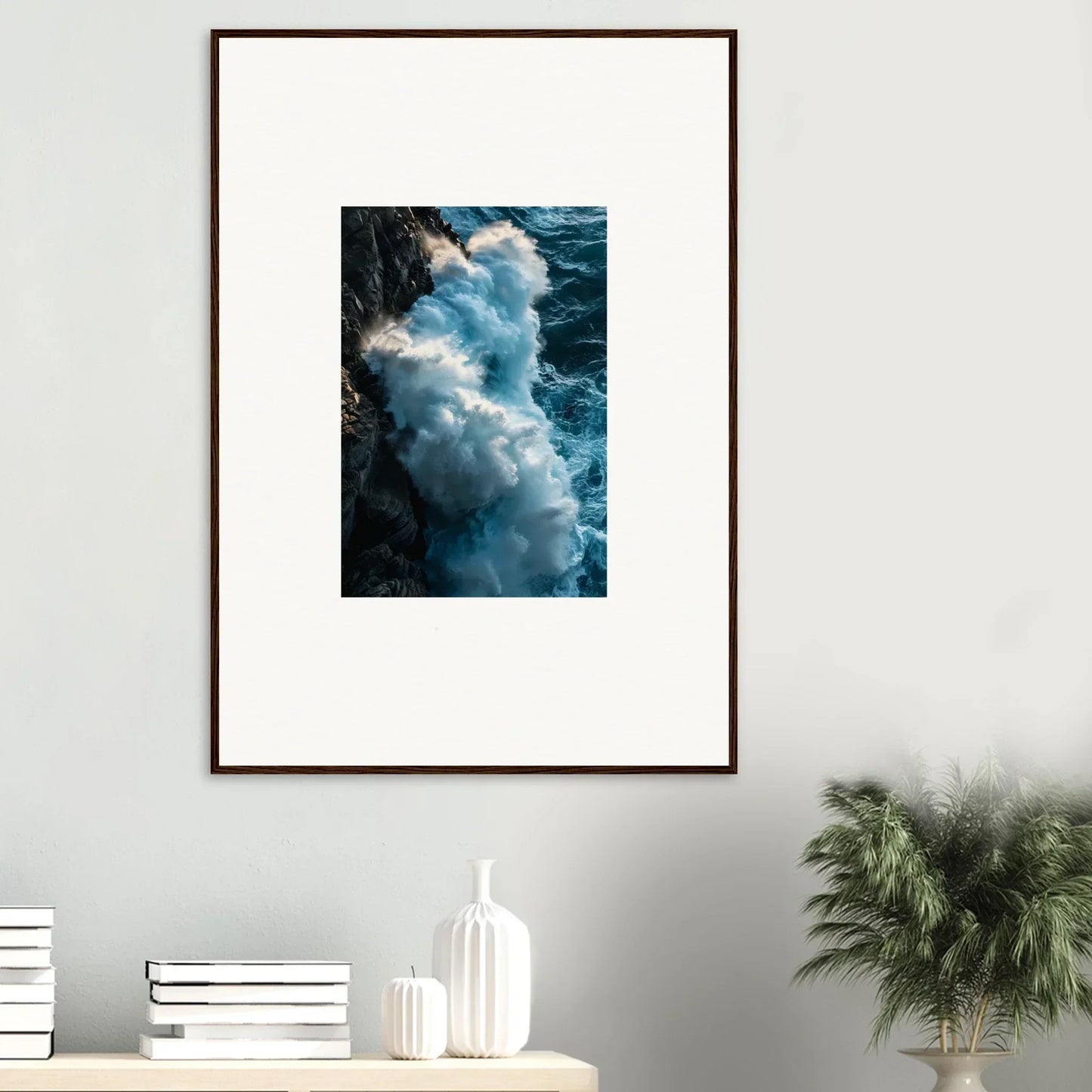 Framed wall art of crashing ocean waves against a rocky cliff for stylish room decor