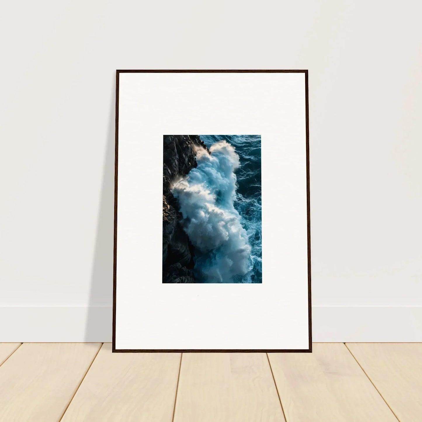 Framed wall art of ocean waves crashing on a rocky cliff, perfect for room decor