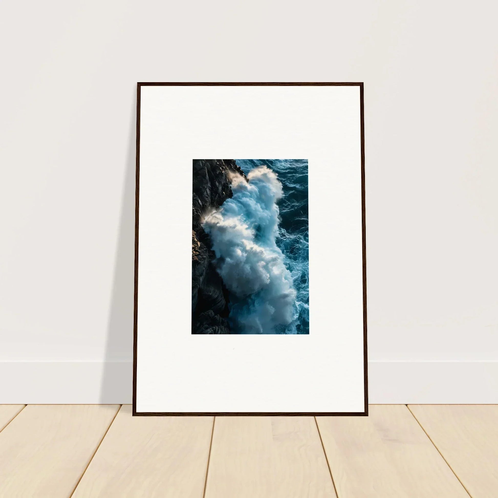 Framed wall art of ocean waves crashing on a rocky cliff, perfect for room decor