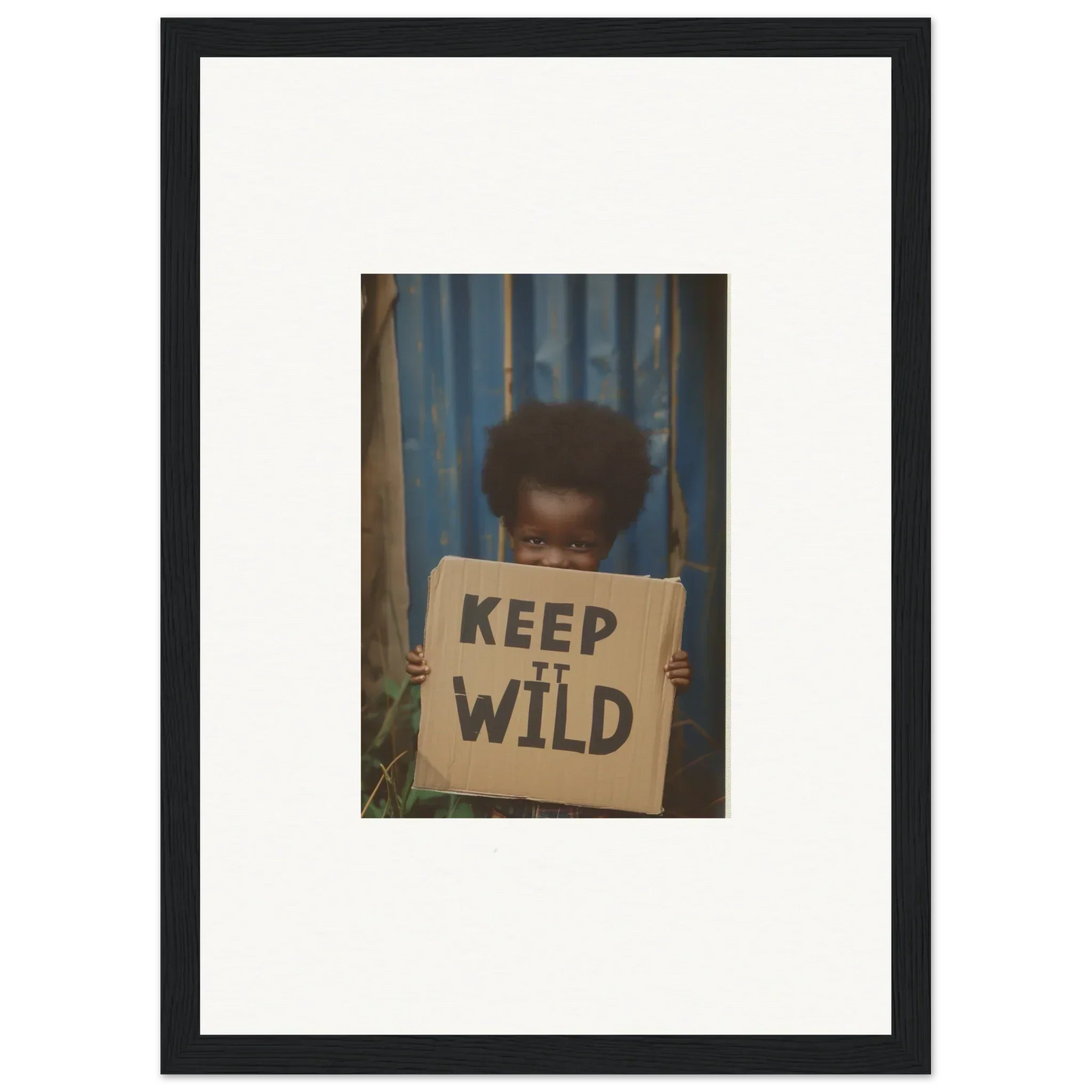 Framed photograph of a person holding a Keep It Wild sign for innocent harmony room decoration