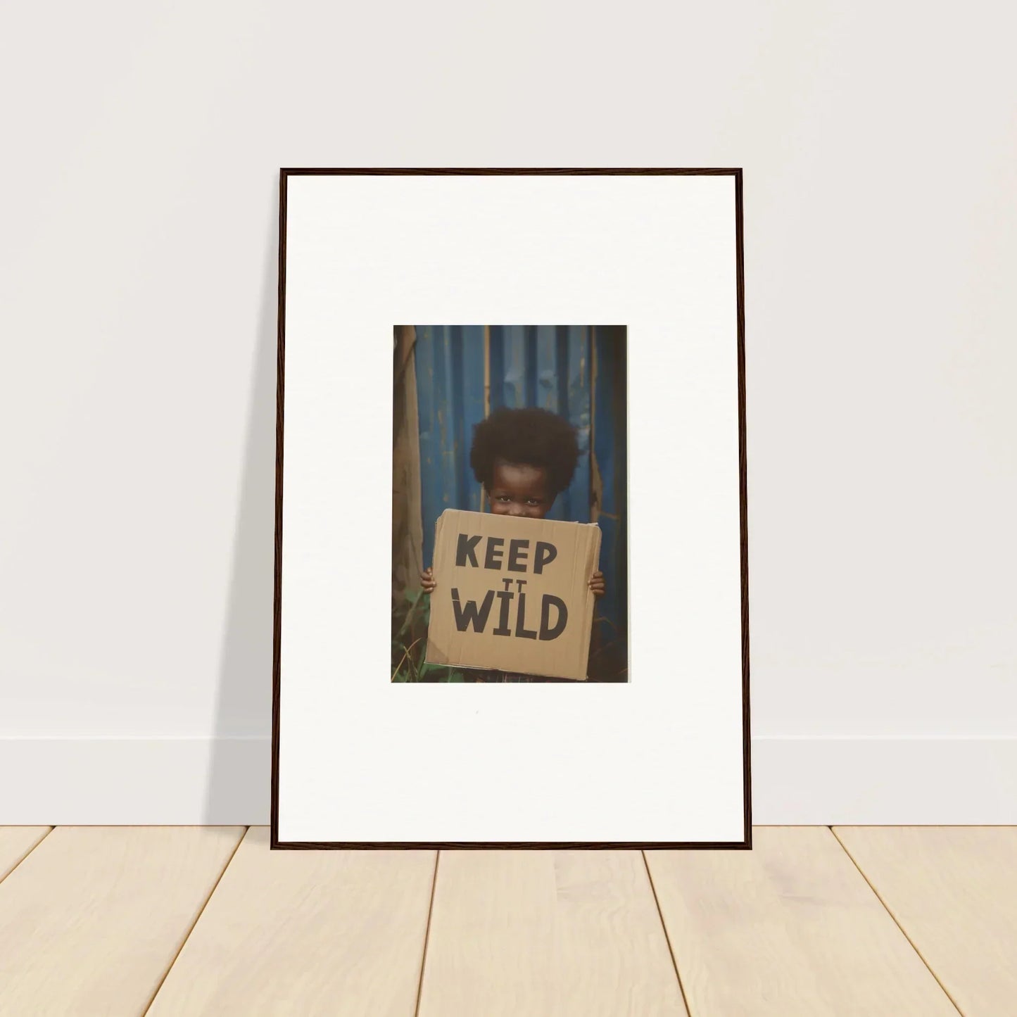 Framed photograph of a person with a KEEP WILD sign for cool room decoration