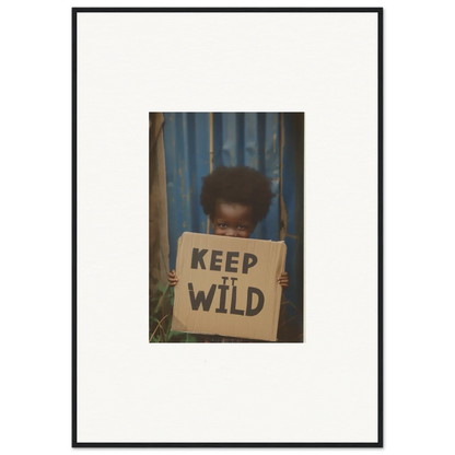 Framed photograph of a person holding a KEEP IT WILD sign for room decoration