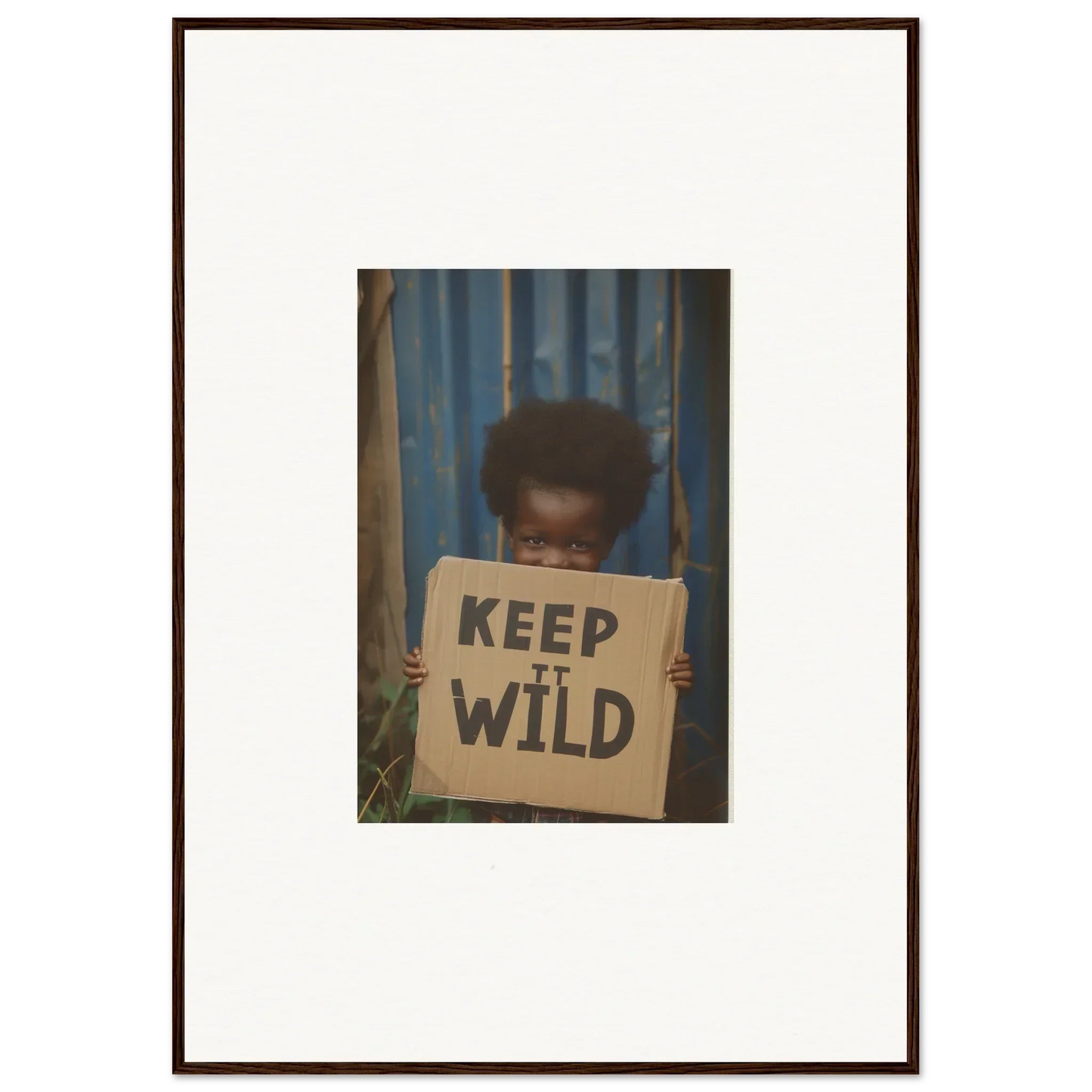 Framed photograph of a person with a KEEP IT WILD sign for room decoration